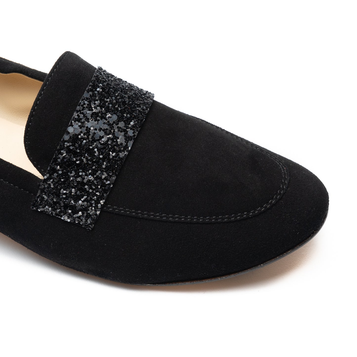 A pair of black flats with sparkle detail on the toe for women.