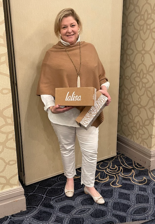 PErson using Beige Ballet type Shoe holding a LAlisa Shoebox